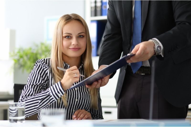 Customer signing her collateral lending contract,