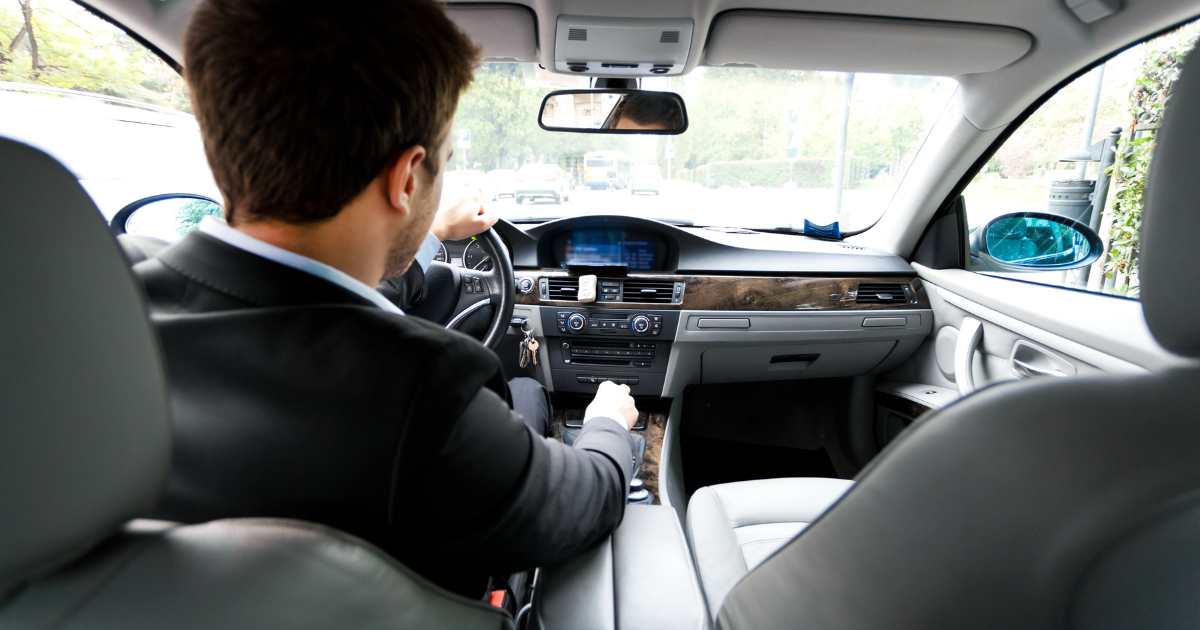 A businessman driving a shared car.